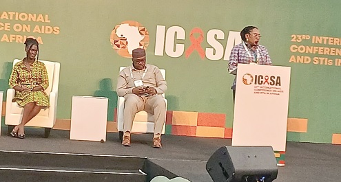 Dr Angela Ackon, Technical Officer, Quality and Safety of the WHO Ghana Office, making her presentation, while Dr Mavis Boakye-Yiadom (seated left), Head, Department of Clinical Research of the Centre for Plant Medicine Research, Mampong Akuapem in the Eastern Region, and another official listen
